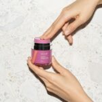 Vella Bioscience woman Holding Bottle